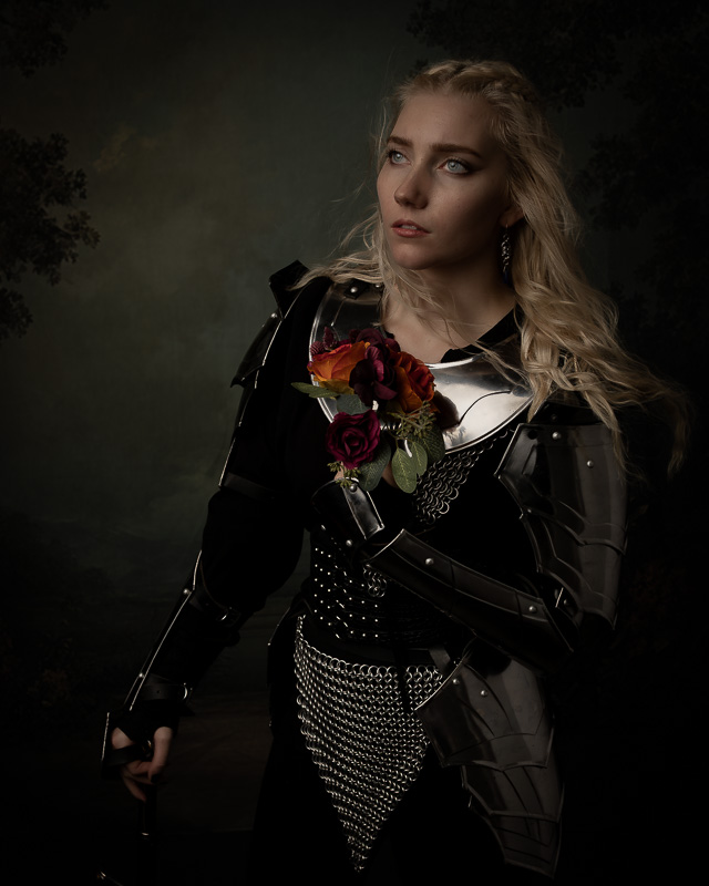 Portrait of a woman in black armor adorned with roses.